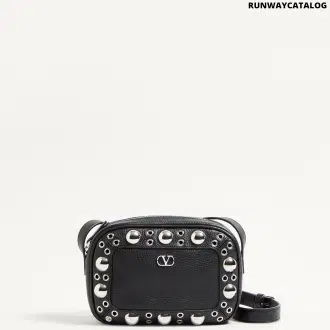 Valentino Garavani Nellcôte shoulder bag in grainy calfskin leather, featuring ball stud and rivet detailing, a VLogo Signature, palladium-finish hardware, and an adjustable leather strap for cross-body wear.