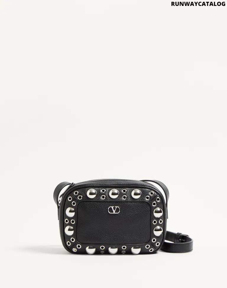 Valentino Garavani Nellcôte shoulder bag in grainy calfskin leather, featuring ball stud and rivet detailing, a VLogo Signature, palladium-finish hardware, and an adjustable leather strap for cross-body wear.